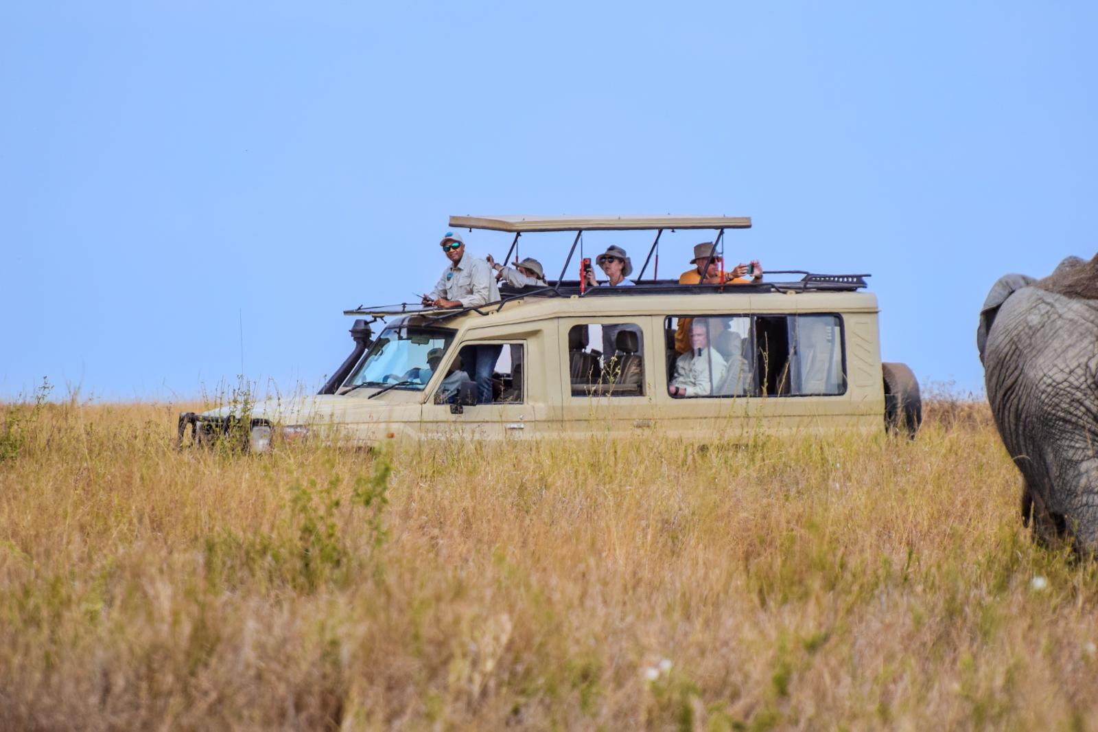Kiboko Safaris guides standing beside the safari vehicle